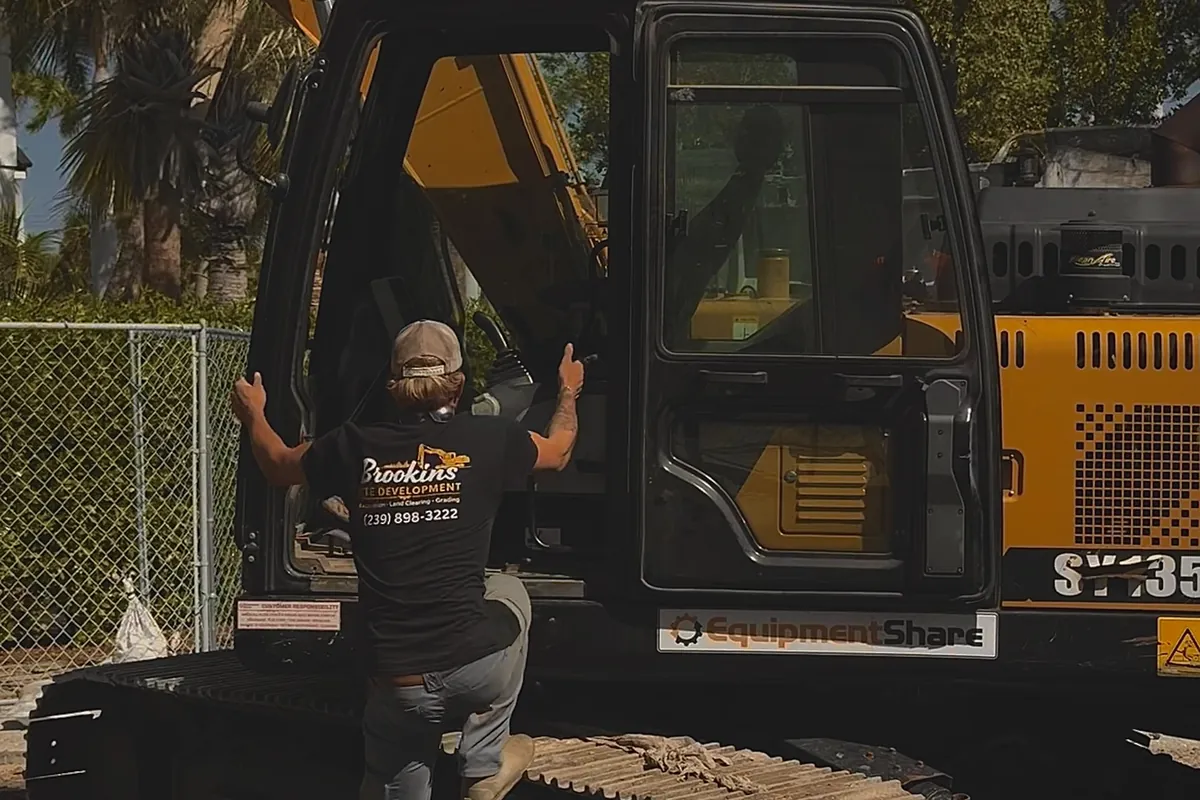 Brookins Site Development excavator operator on the job in Southwest Florida